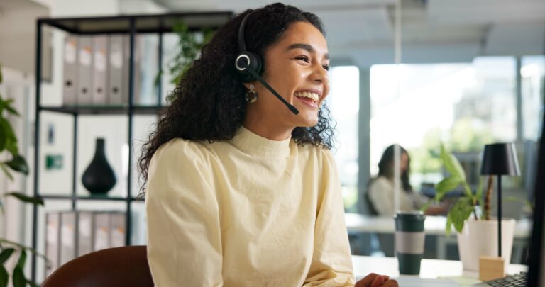 Laughing, happy woman and customer service in call center with agent, communication and online consulting. Funny joke, friendly consultant and sales office for CRM contact support, advice or business.