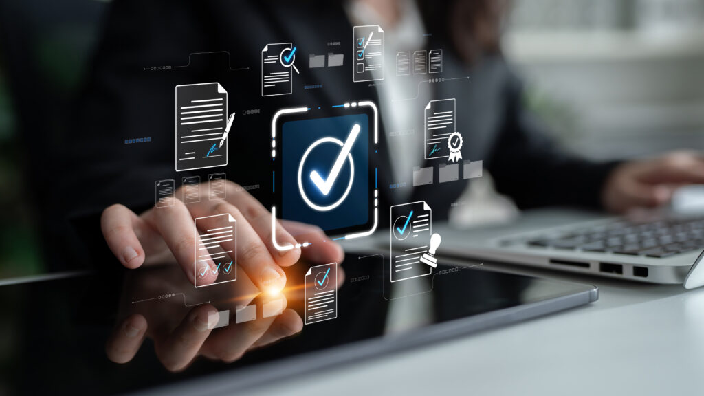 Business professional interacting with digital check mark interface while managing documents and data on modern touchscreen device in modern office environment Sigmoid